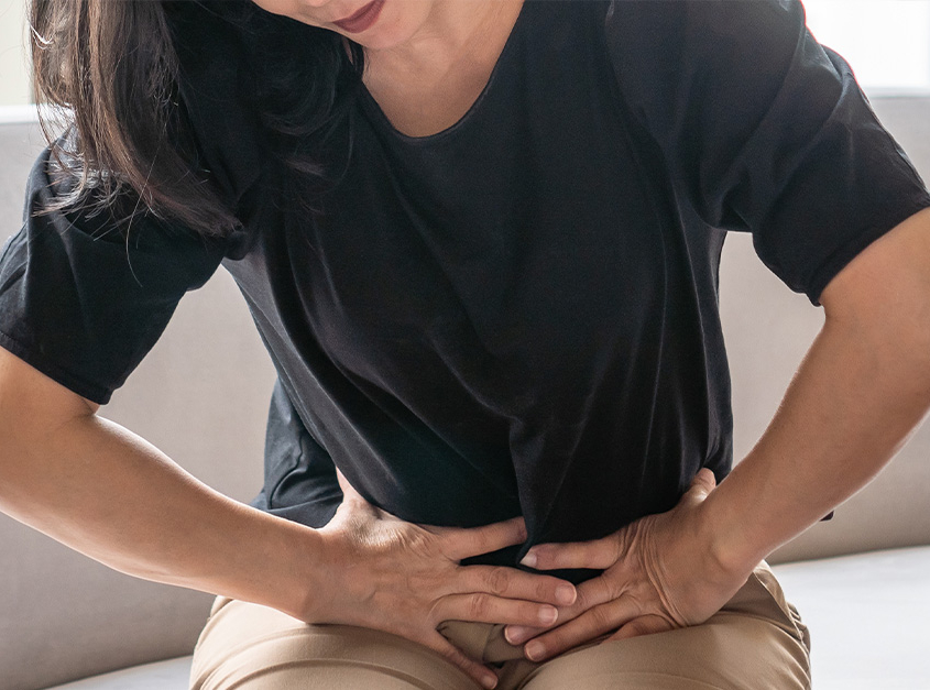 A lady experiencing abdominal pain from uterine cancer.